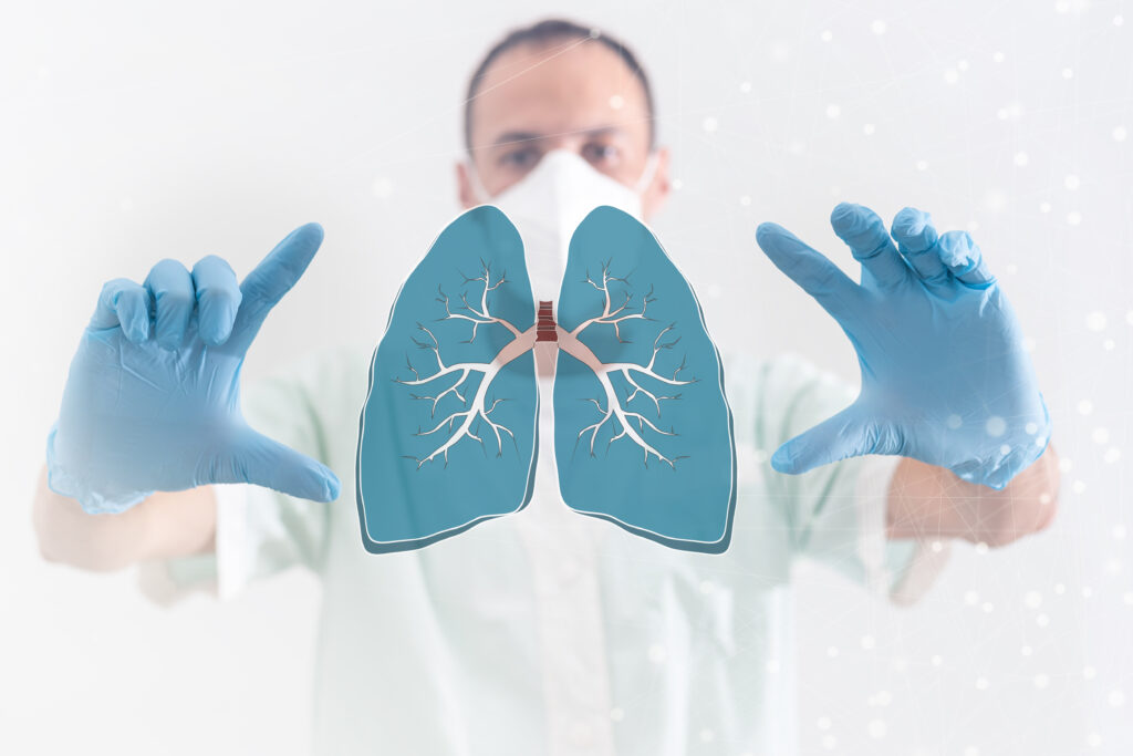 doctor holding virtual lungs between his hands on a display